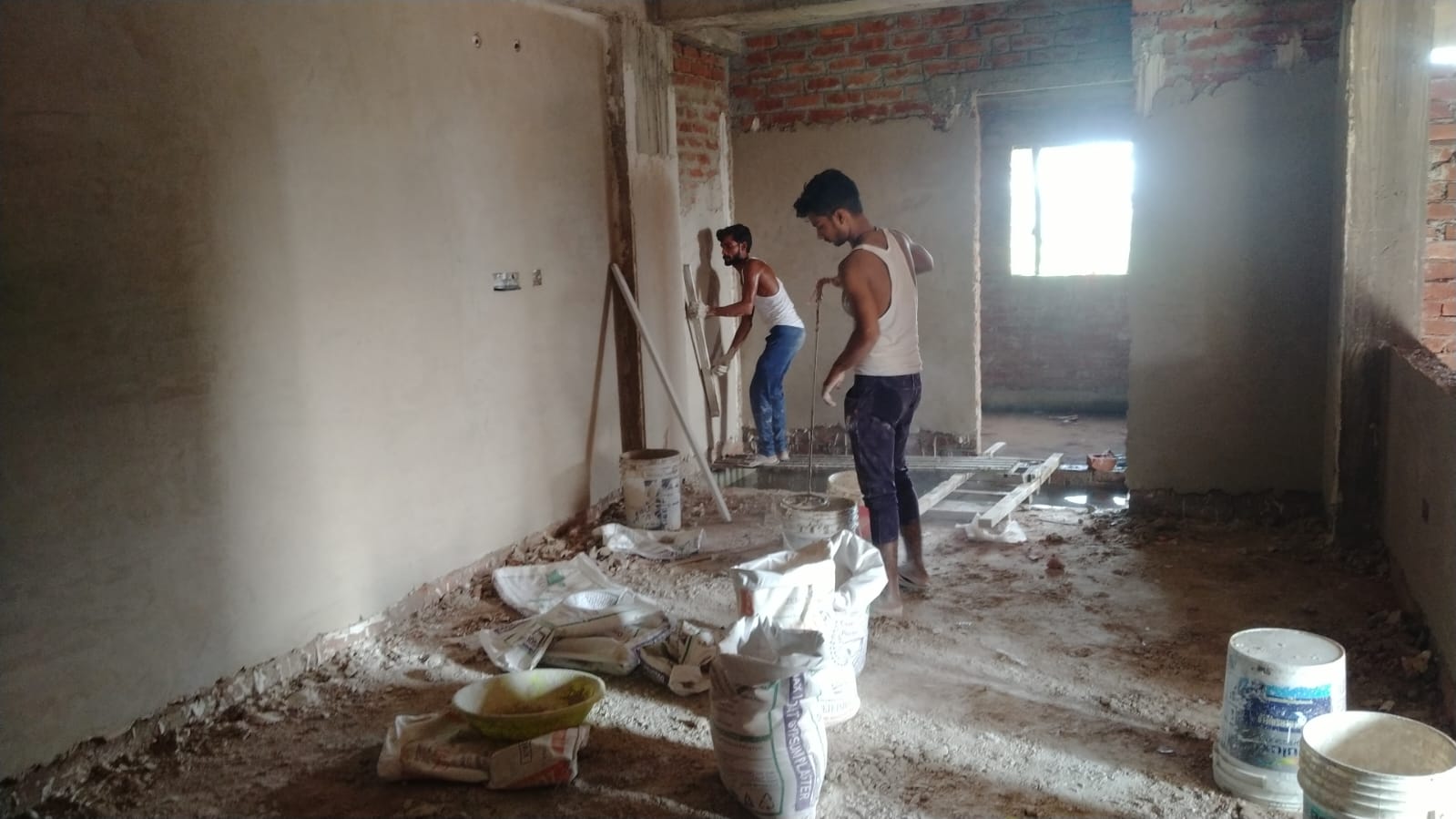 Plastering team on indoor site